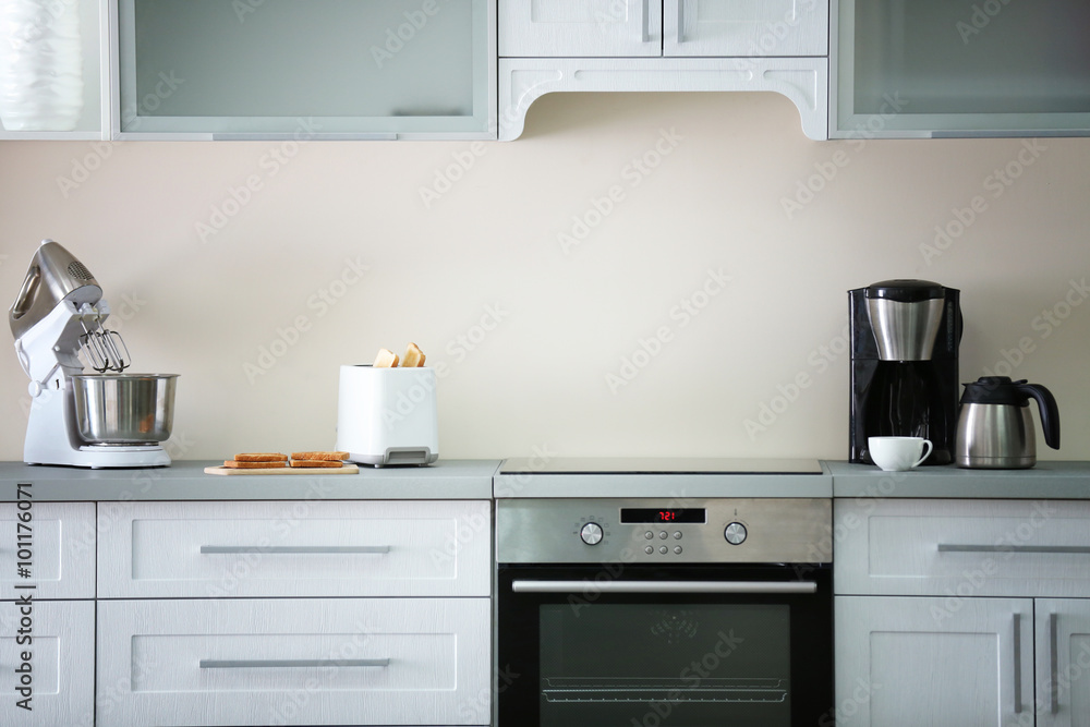 Fototapeta premium Toaster with coffee maker and mixer on a light kitchen table