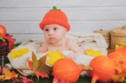 baby in the basket with pumpkins. autumn photo