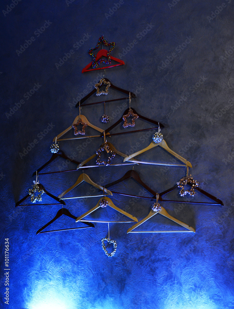 Christmas tree of hangers on a dark grey wall Christmas tree of hangers on a dark grey wall