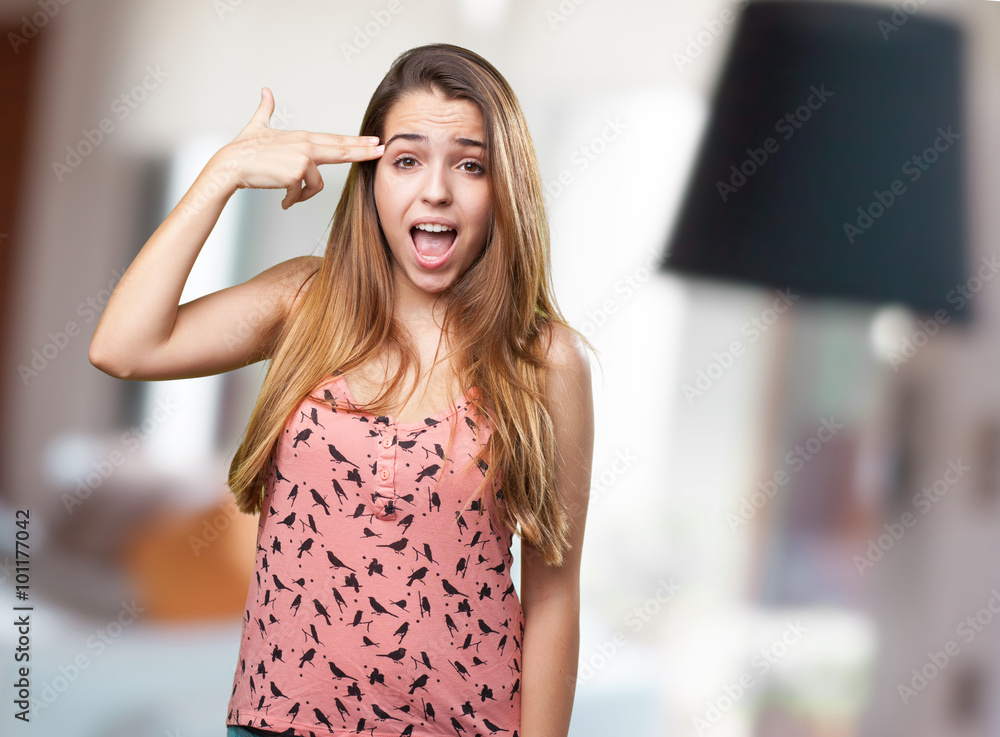 young woman joking doing a suicide gesture