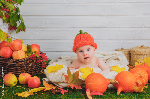 baby in the basket with pumpkins. autumn photo