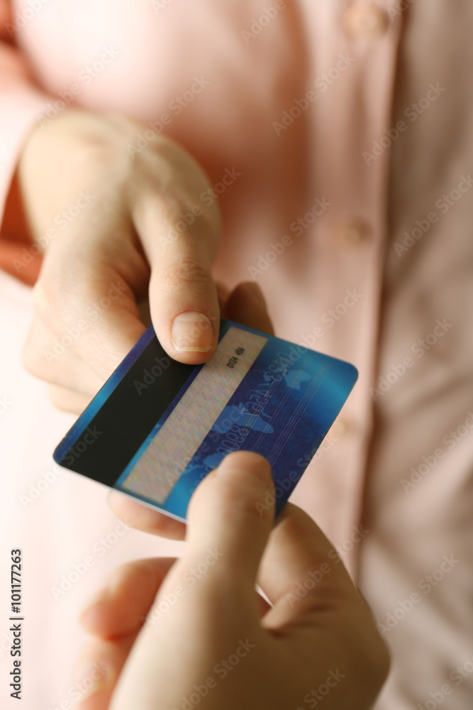 Hands holding blue credit card on white background Hands holding blue credit card on white background