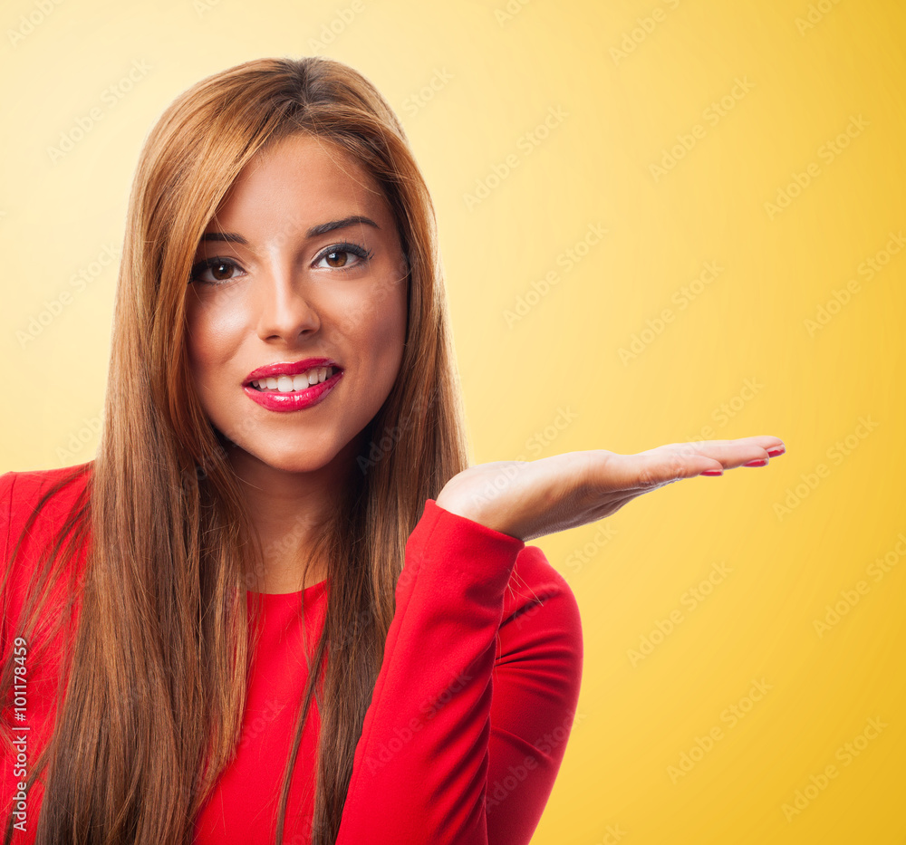 portrait of a beautiful young woman showing an imaginary product portrait of a beautiful young woman showing an imaginary product