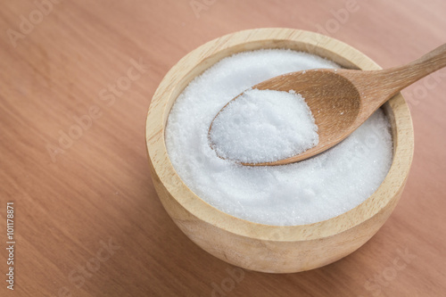 White salt in wooden bowl ,on wooden table