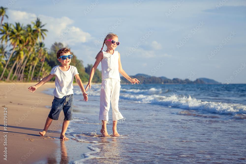 Happy children playing on the beach at the day time. Happy children playing on the beach at the day time.