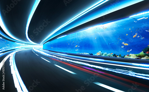 Fototapeta Naklejka Na Ścianę i Meble -  Abstract blurred speed motion road in glass tunnel underwater,with light trail