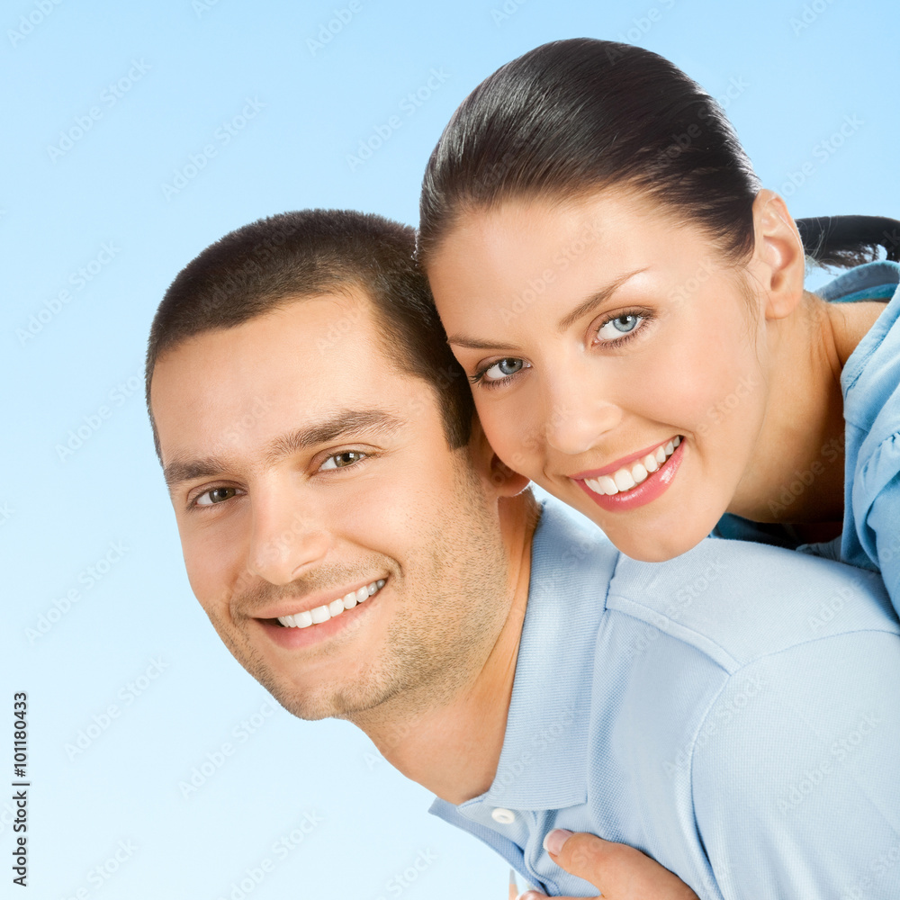 Young happy smiling amorous attractive couple, on blue sky Young happy smiling amorous attractive couple, on blue sky