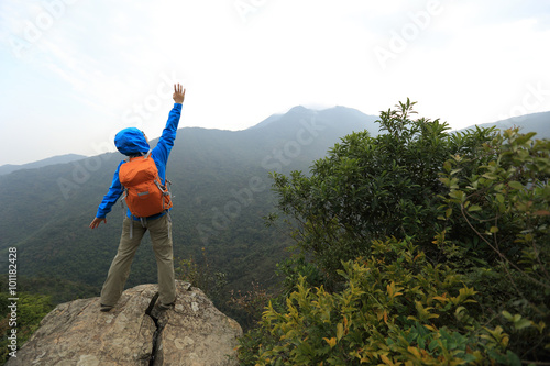 successful woman hiker at mountain peak