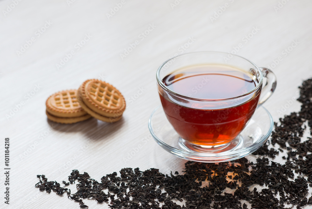 black tea in clear glass cup is on the table black tea in clear glass cup is on the table