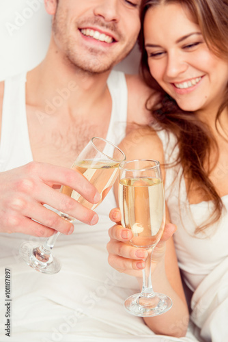 Cheers! Couple in love celebrate honeymoon with champagne on the