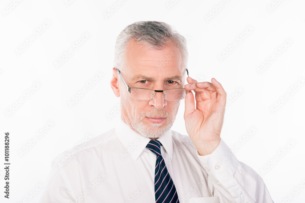 Old strict businessman in shirt and tie holding his glasses Old strict businessman in shirt and tie holding his glasses