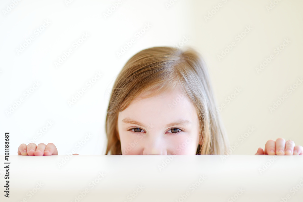 Portrait of a cute little girl at home