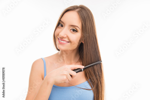 beautiful cute girl combing her long hair