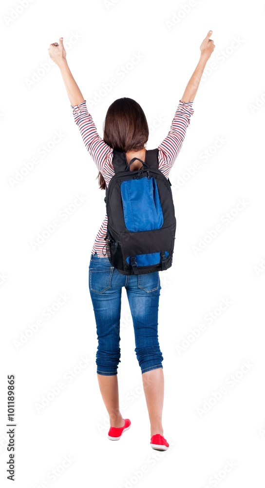 Back view of brunette woman with backpack thumbs up. Back view of brunette woman with backpack thumbs up.