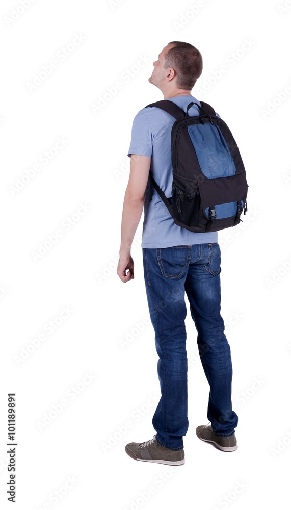 Fototapeta premium Back view of man with backpack looking up.