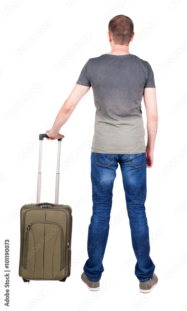 Back view of man with green suitcase looking up. Back view of man with green suitcase looking up.