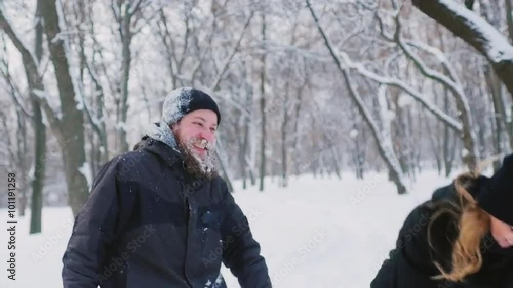 Bearded man and woman having fun in the winter forest Bearded man and woman having fun in the winter forest