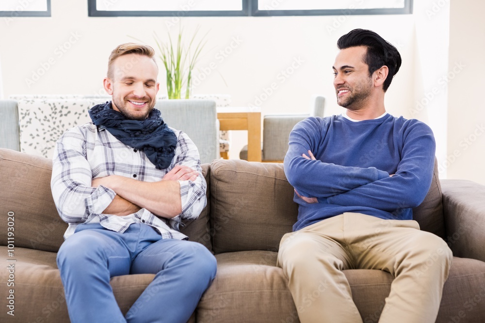 Gay couple smiling on the couch