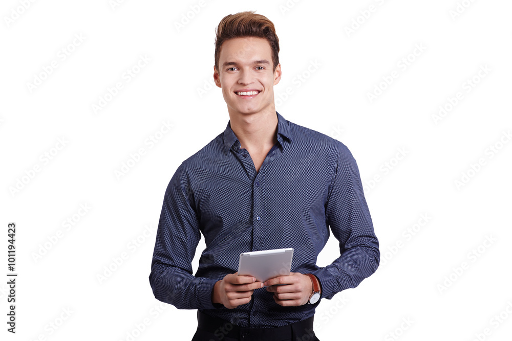 Smiling young man using tablet computer against a white background Smiling young man using tablet computer against a white background