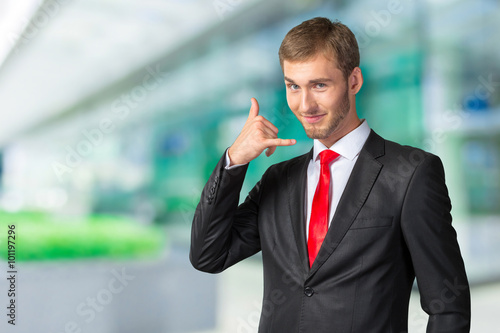 Young Businessman showing  Call me  sign