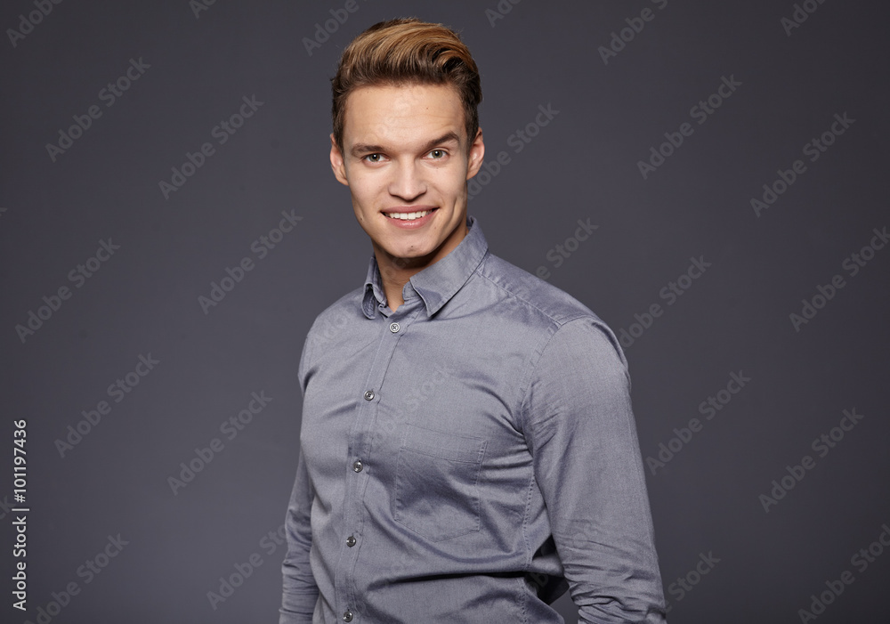 Cool businessman standing on grey background Cool businessman standing on grey background