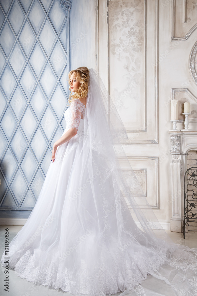 Obraz premium photo of a beautiful blonde bride in a luxurious wedding dress in elegant expensive interior