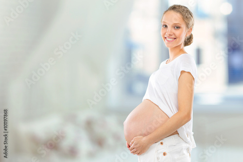 Portrait of the young happy smiling pregnant woman