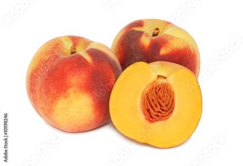 Two whole and a half ripe peaches without leaves (isolated)