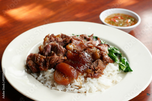 Stewed pork leg on rice with spicy sour sauce