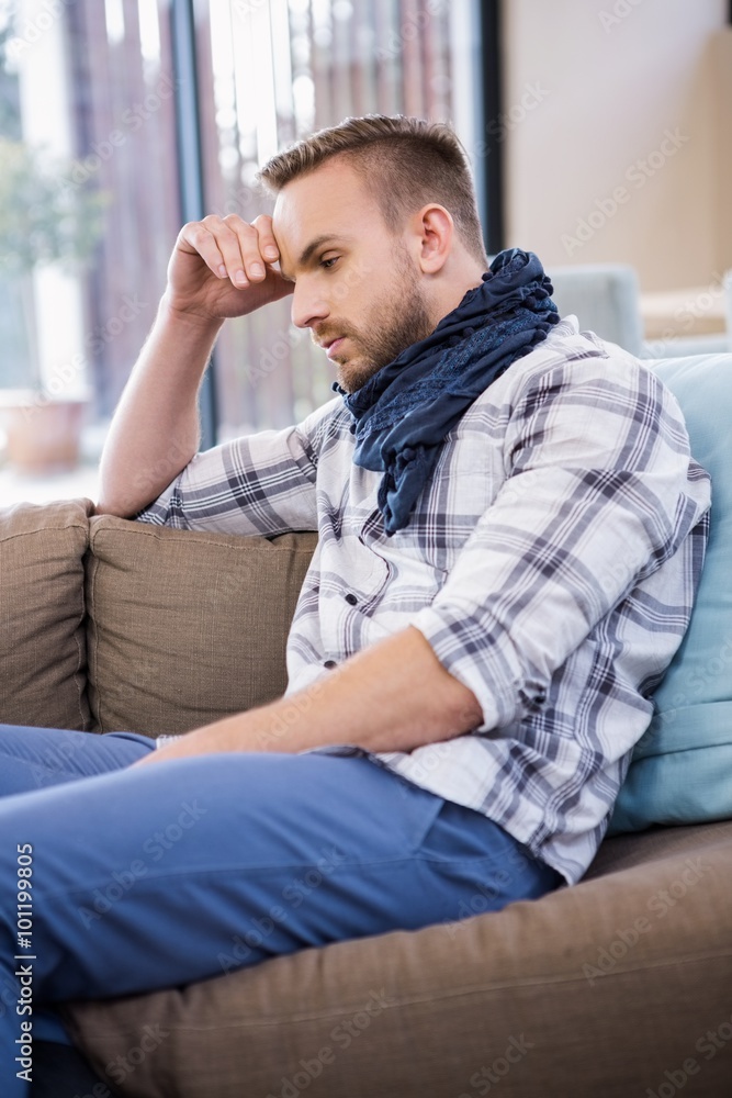 Worried man thinking on the couch Worried man thinking on the couch