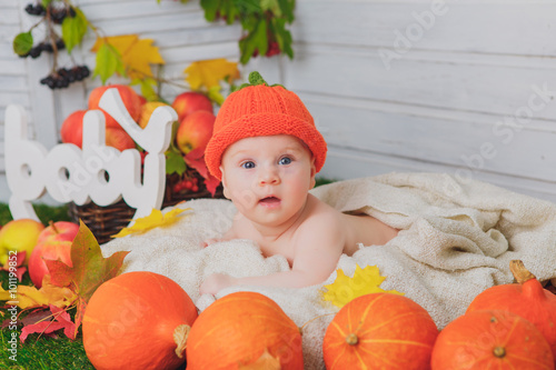 baby in the basket with pumpkins. autumn photo