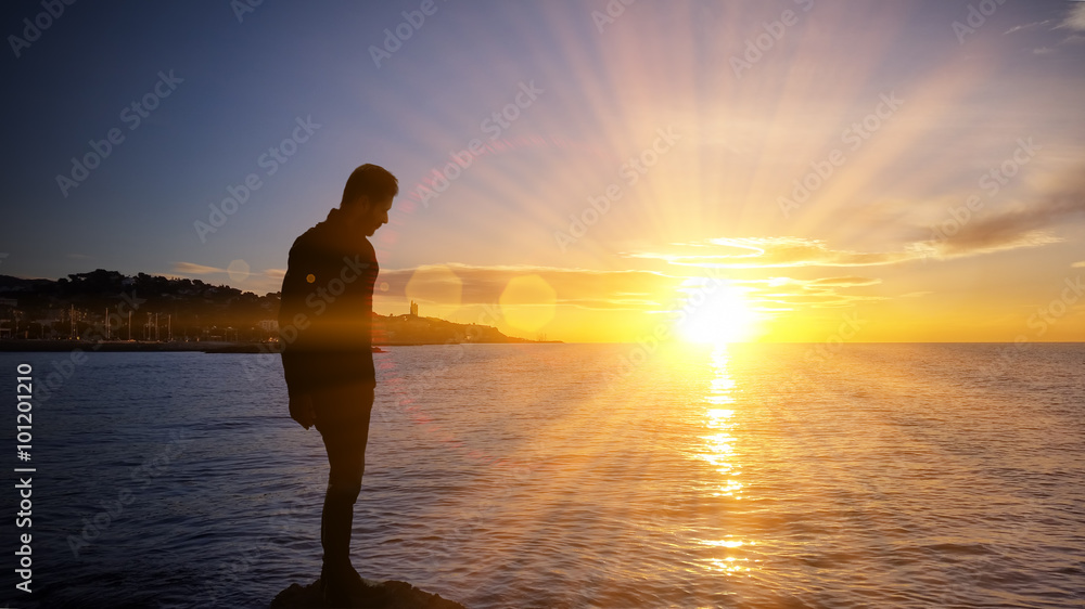 Man and sunset on the sea