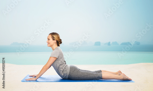 woman making yoga in dog pose on mat