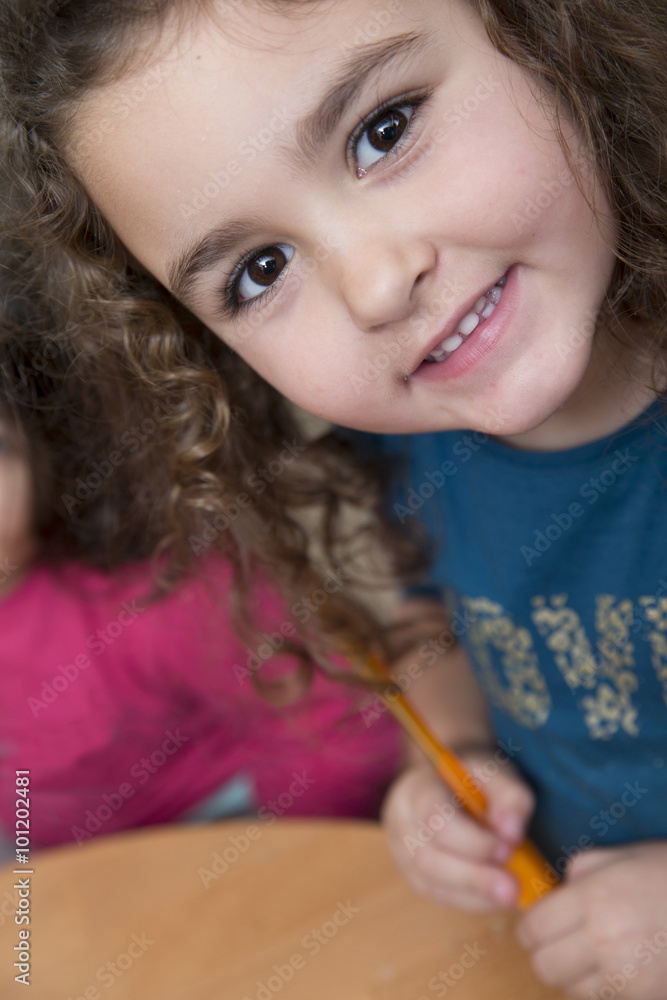 Funny little girl siling while looking at camera Funny little girl siling while looking at camera