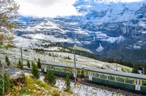 Mountain train crossing the snowy Swiss Alps