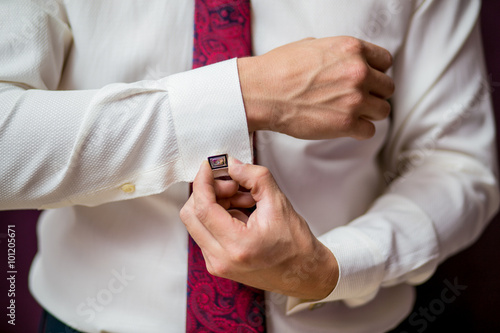 A man in a shirt button cufflink closeup © EdNurg