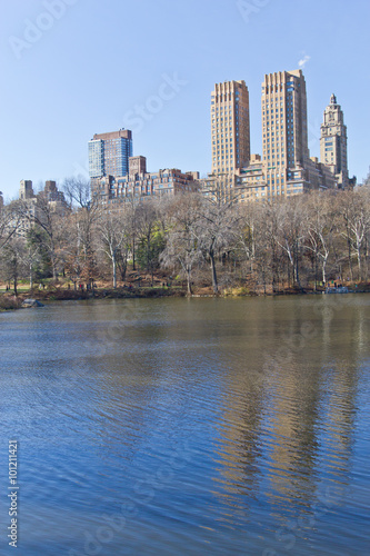 Central Park lake with building and tree reflection