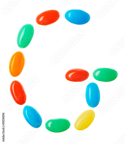 G letter made of multicolored candies isolated on white