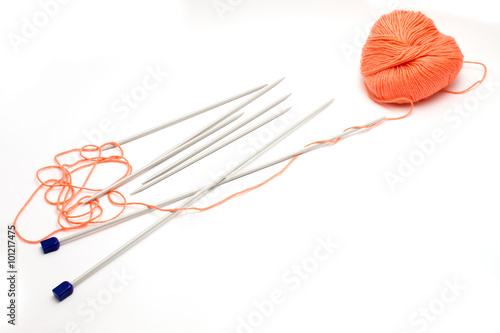 knitting needles and a skein of wool yarn