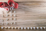 Wooden  heart on a rustic background. Red shoes. Valentine's Day. View from above. Space for text.