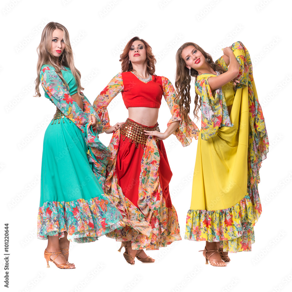 three female dancers posing, isolated on white in full length