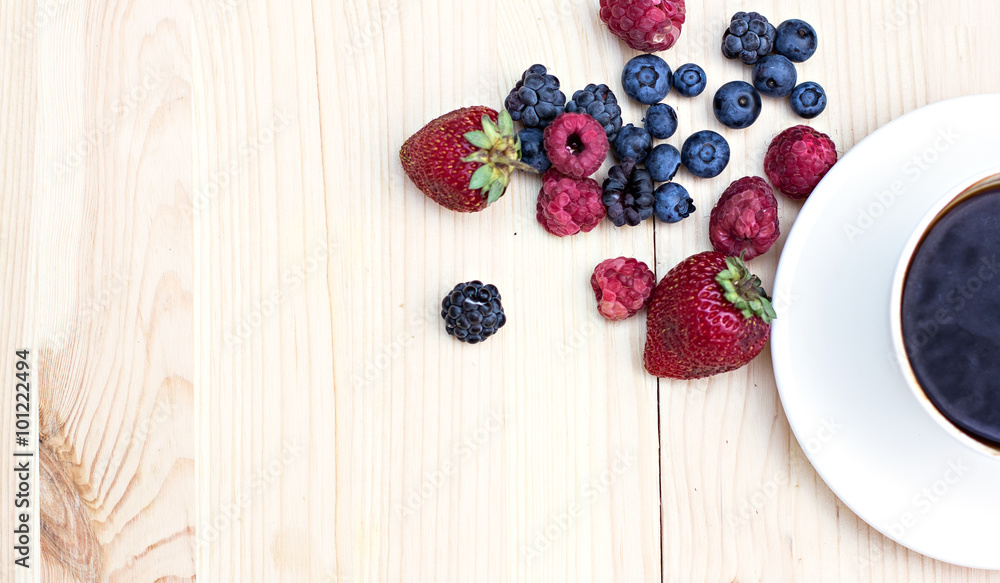 Summer berries (strawberries, raspberries, blueberries, blackberries) and a cup of coffee Summer berries (strawberries, raspberries, blueberries, blackberries) and a cup of coffee