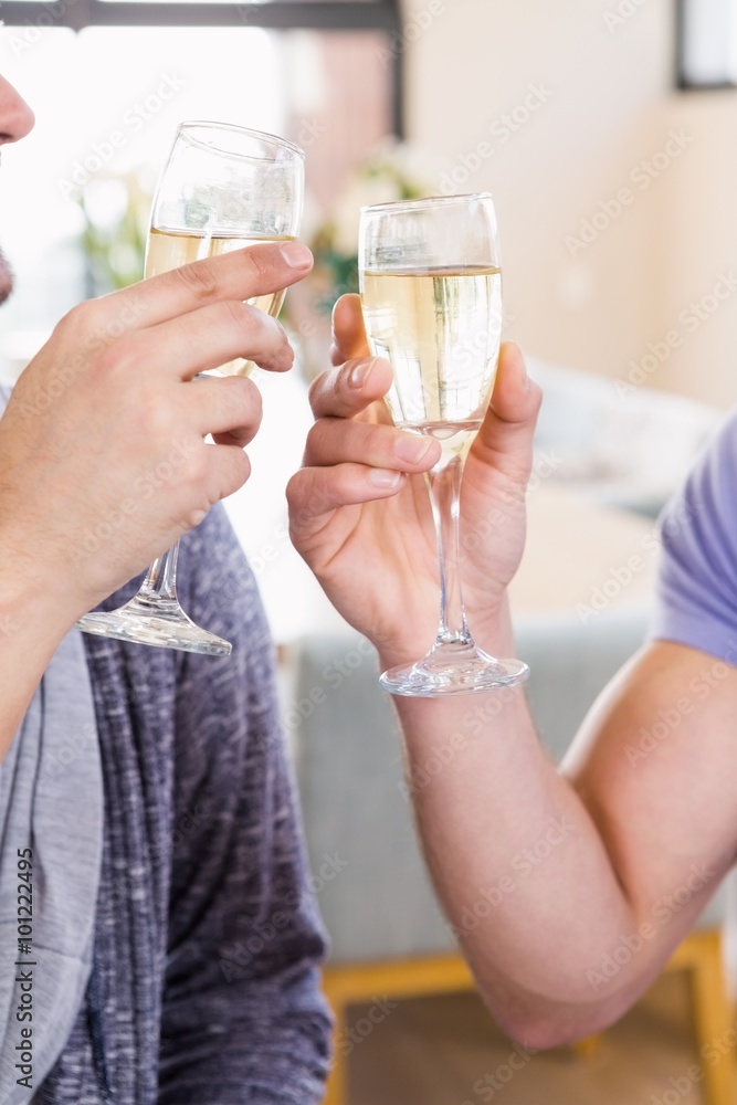 Smiling gay couple toasting with champagne Smiling gay couple toasting with champagne