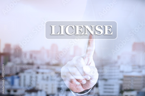 Businessman hand touch screen graph on LICENSE. Can be used for your ad. photo