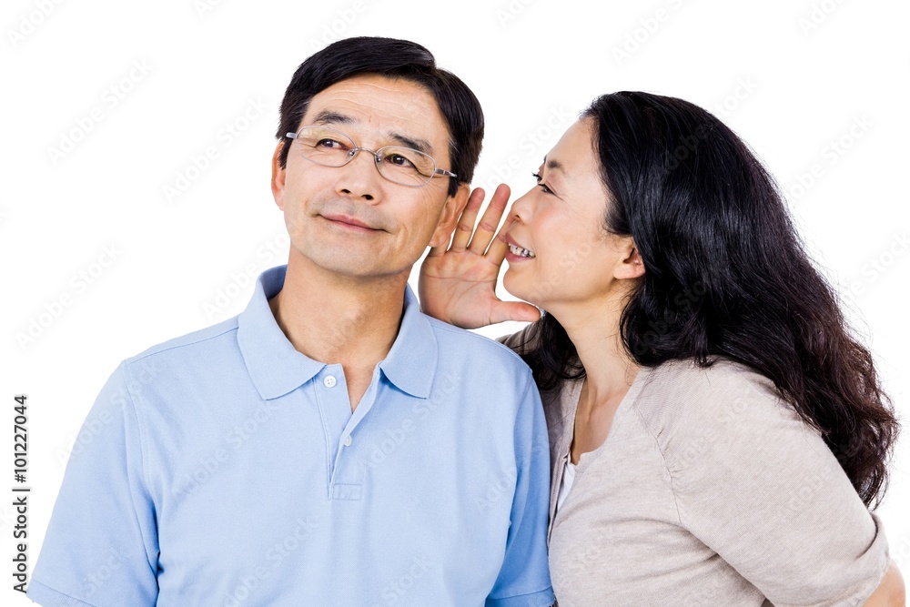 Woman whispering into partners ear Woman whispering into partners ear