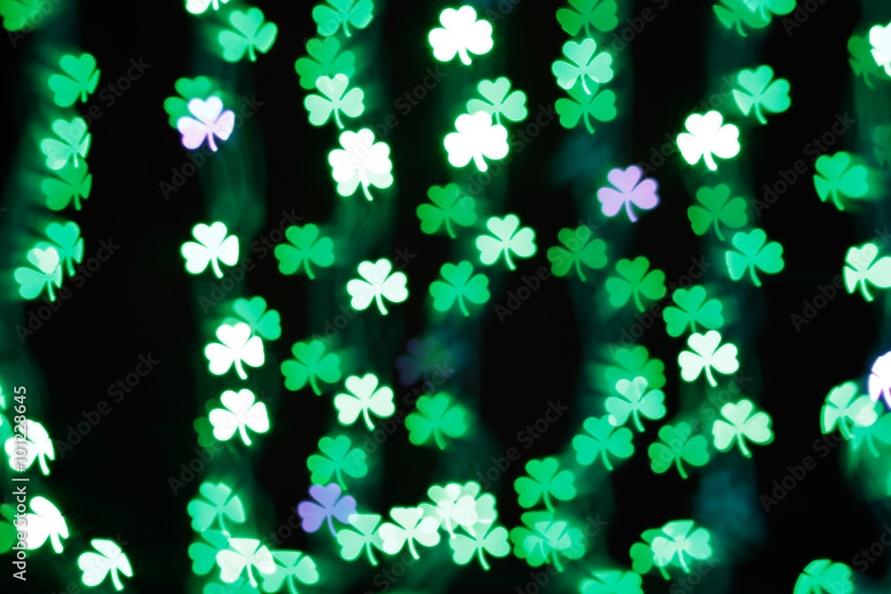 Blurring lights bokeh background of green clovers. Happy Saint Patrick's Day Background Blurring lights bokeh background of green clovers. Happy Saint Patrick's Day Background