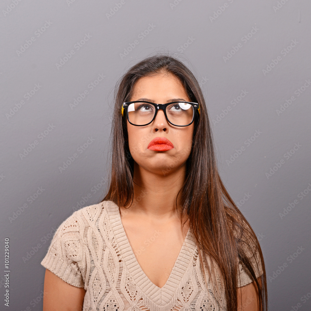 Portrait of a sad woman against gray background