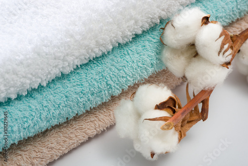 Stack of bath towels with cotton branch