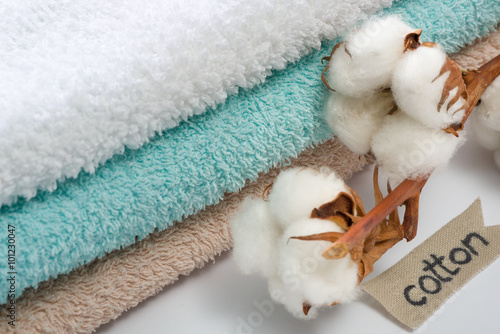 Stack of bath towels with cotton branch