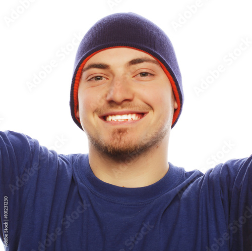 young man holding camera and making selfie 